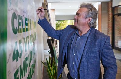 CEO Pat Covey signs Employee Ownership sign